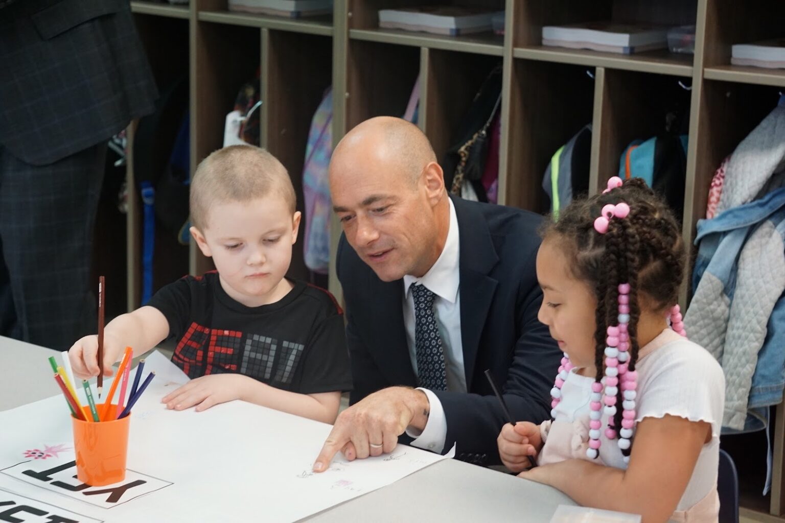 Landsman in classroom with students